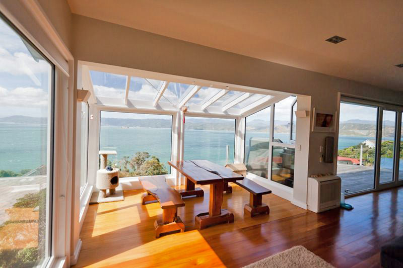 room with sea view through different windows in different shapes and sizes